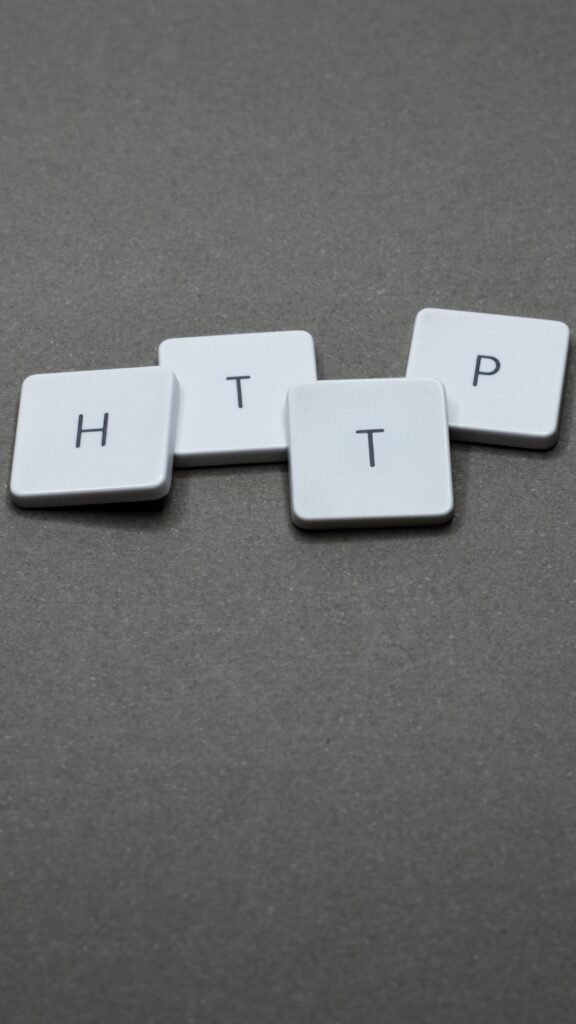 Home High-angle photo of keyboard tiles spelling HTTP on a dark background.