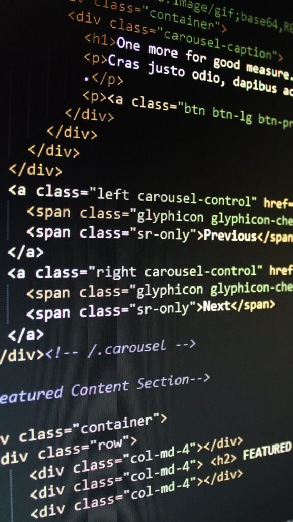 Home Close-up of HTML code displayed on a computer monitor, showcasing web development.